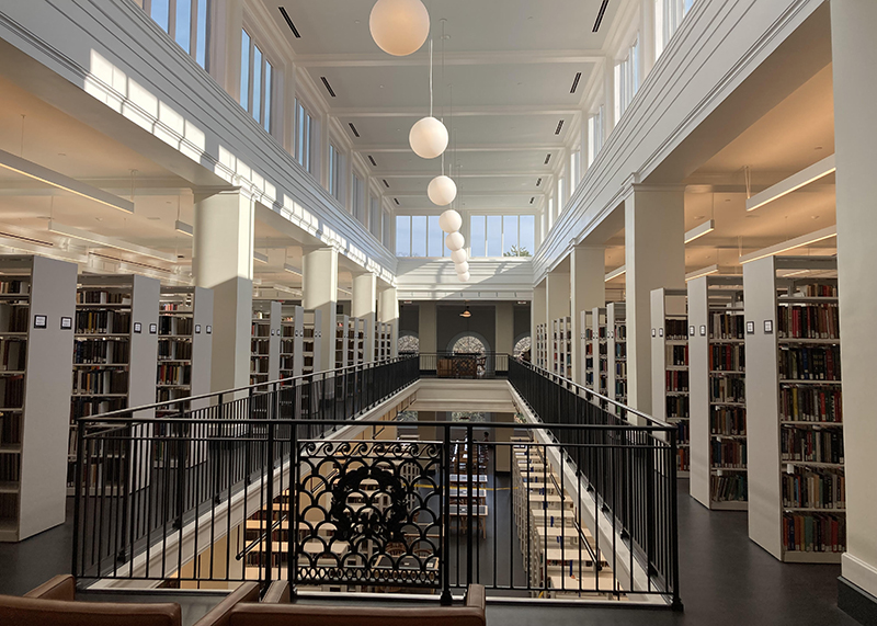 The fifth floor of Alderman Library features a two filled "stacks" sections of books, as well as clerestory windows and an aperature looking down to the fourth floor below.